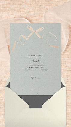 an open envelope with a ribbon on it