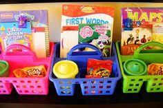 three plastic baskets filled with books and toys