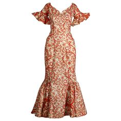 Rare 1950s Hawaiian dress made by Surf and Shore in Honolulu. Mouth watering vintage hand pulled screen printed fabric in orange, white and metallic gold. Dramatic flared bell sleeves and plunging neckline. 1950s bombshell hourglass silhouette! Unlined with rear metal zip and hook closure. The fabric content feels like cotton but is unmarked. Fits like a modern size XS. The bust measures 34", waist, 24", hips 35", and total length 52.5". The bottom hem has about 1.5"-2" that can be let out. Excellent vintage condition with no noted flaws. The fabric is still nice and crisp. Made in the USA. Islander Dresses Design, Puletasi Designs, Hawaiian Dress Pattern, Traditional Hawaiian Dress, 1950s Bombshell, Samoan Clothing, Dress Hawaiian Style, Samoan Dress, Island Style Clothing