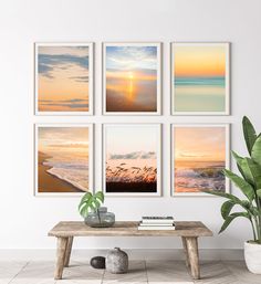 a living room with four pictures on the wall and a coffee table in front of it