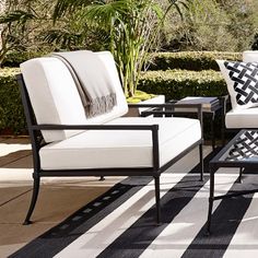 an outdoor patio with black and white furniture