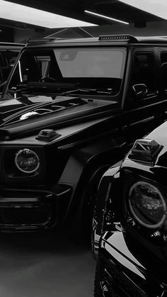 black and white photograph of cars parked in a garage