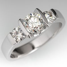 three stone diamond ring in white gold with diamonds on the sides and four stones at the top