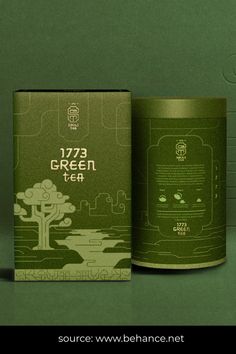 a green tea canister sitting on top of a table next to a box with an image of a tree