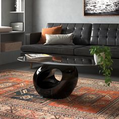 a living room with a couch, coffee table and rugs on the floor in front of it