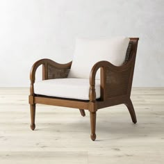 a wooden chair with white cushions on top of a hard wood floor