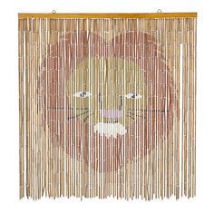 a close up of a bamboo curtain with a face on it