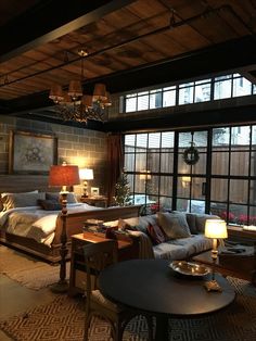 a living room filled with furniture and lots of windows