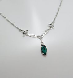 This is a new handmade necklace. It is made with antiqued silver plated Celtic knots, accented with a high quality EMERALD GREEN glass jewel that sparkles like crystal. Decorated portion is 2 1/2" wide and 1 1/4" tall in the center. Necklace is adjustable 15-18" with a lobster clasp and chain extender. If you would like a different length, please send us a message.Matching earrings and headpiece are listed in our store in a variety of stone colors. If you don't see items with a color you want, f Emerald Jewelry Silver, Silver And Emerald Green, Necklace Green, Silver And Green Jewelry, Dark Green Jewelry, Formal Silver Hallmarked Emerald Necklace, Green Crystal Necklace, Elegant Silver Emerald Bridal Necklace, Handmade Fantasy Green Necklaces