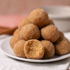 a white plate topped with sugar covered donuts