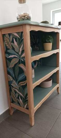 a wooden shelf with plants on top of it