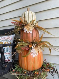 two pumpkins are stacked on top of each other