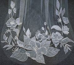 the sheer fabric is decorated with flowers and leaves