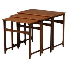 three wooden nesting tables sitting on top of each other