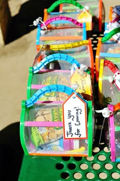 there are many small plastic baskets on the table with price tags attached to each one