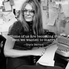 a woman sitting at a desk in front of a typewriter with a quote on it