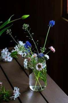 some flowers are sitting in a vase on a table