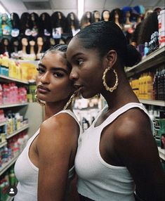 two women standing next to each other in a store