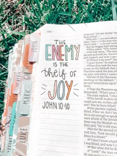 an open bible with the words, the enemy is the thief of joy