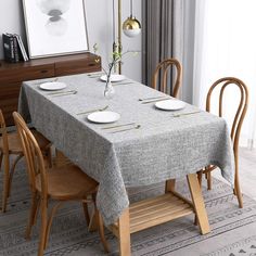 a dining room table is set with plates and place settings for two people to eat