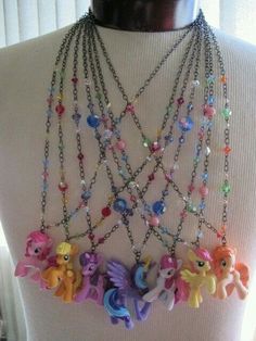 the necklace is decorated with many little ponys on it's chain and beads