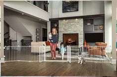 a woman and two children in a living room with a dog on the floor next to them