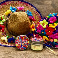 a straw hat, candle, and other items on top of a wooden table together