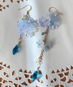 blue Sakura Flower Earrings The blue sakura flower earrings feature three glazed sakura and one crystal drop. They are really comfortable for everyday wear.  Available in GOLD and Silver finish! M A T E R I A L S * A N D * S I Z E  The hook is 14K gold filled - Length: 80mm(without the hook) - Width: 23mm Whimsical Blue Jewelry With Flower Charm, Handmade Blue Whimsical Flower Earrings, Blue Flower Charm Earrings For Spring, Blue Earrings With Flower Charm For Spring, Whimsical Handmade Blue Flower Earrings, Whimsical Blue Flower Earrings For Gift, Blue Whimsical Dangle Flower Earrings, Whimsical Blue Dangle Flower Earrings, Blue Dangle Earrings For Spring