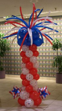 the balloon column is decorated with red, white and blue balloons in an office lobby