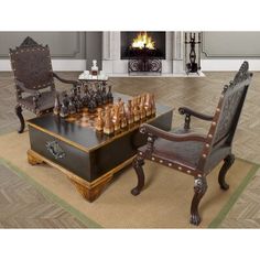 a chess set sitting on top of a wooden table next to a chair and fire place