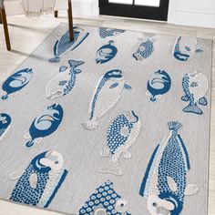 a blue and white rug with fish on it