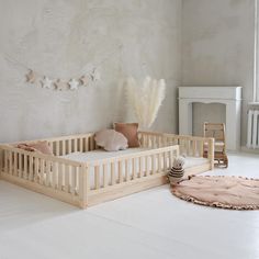 a baby's room with a crib, bed and rug on the floor