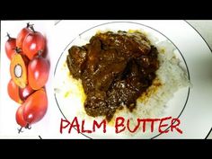 a white plate topped with meat and rice covered in sauce next to some cherry tomatoes