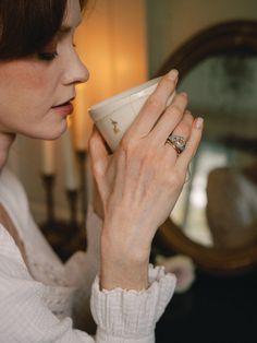 a woman holding a coffee cup in her right hand