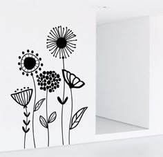 a black and white flower wall decal on the side of a door with an open window