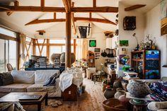 a living room filled with furniture and lots of clutter