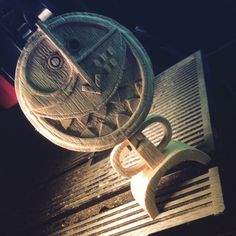 a close up of a metal object on top of a grate in the dark