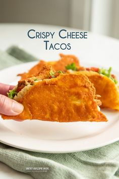 crispy cheese tacos on a white plate with a hand reaching for the food