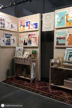 an exhibit booth with art on the walls