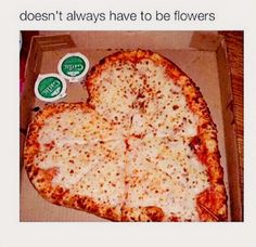 a heart shaped pizza sitting in a box