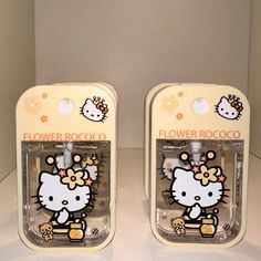 two hello kitty cell phones are on display