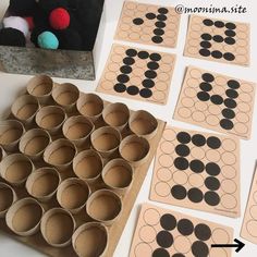 several cardboard circles are arranged on top of a table next to some paper cups and a teddy bear