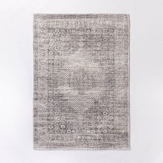 a gray and white rug on a white wall