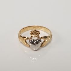 "Thanks for shopping our vintage estate store. We tend to sell well below wholesale and truly hope you enjoy all of our items. Many of the items are one of a kind, so please enjoy scrolling through the pictures and hopefully something will catch your eye. Blacks spots are from camera or reflections. Beautiful estate 14k gold yellow white gold Irish Claddagh infant or baby ring. Retails $299 on sale $149 Ring size: 1 Setting: 3/8\" 8.5mm Band width: 2mm Weight: .1.07 grams Beautiful ring, one tha Classic Heart Jewelry For Collectibles, Classic Heart-shaped Collectible Jewelry, Classic Heart Shaped Collectible Jewelry, Heirloom Engraved Heart Ring For Anniversary, Heirloom Engraved Heart Ring, Vintage 14k Stamped Heart Cut Jewelry, Vintage 14k Gold Jewelry For Valentine's Day, Collectible 14k Gold Heart-shaped Jewelry, Collectible Yellow Gold Birthstone Rings