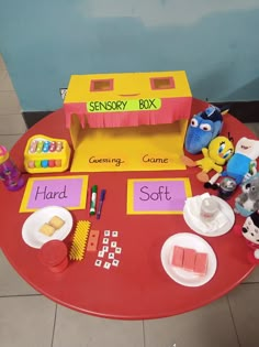 a red table topped with lots of toys