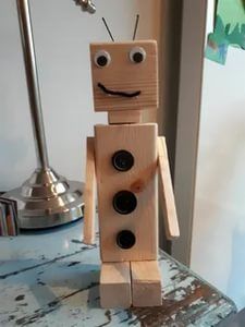 a wooden robot made to look like it is smiling