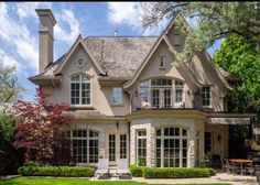 a large house with lots of windows in the front yard