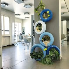 there is a wall decoration made out of tires and plants in the middle of it