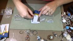 a person is making jewelry on a table