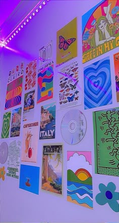 a wall covered in posters and cd's under a purple light with the word italy on it